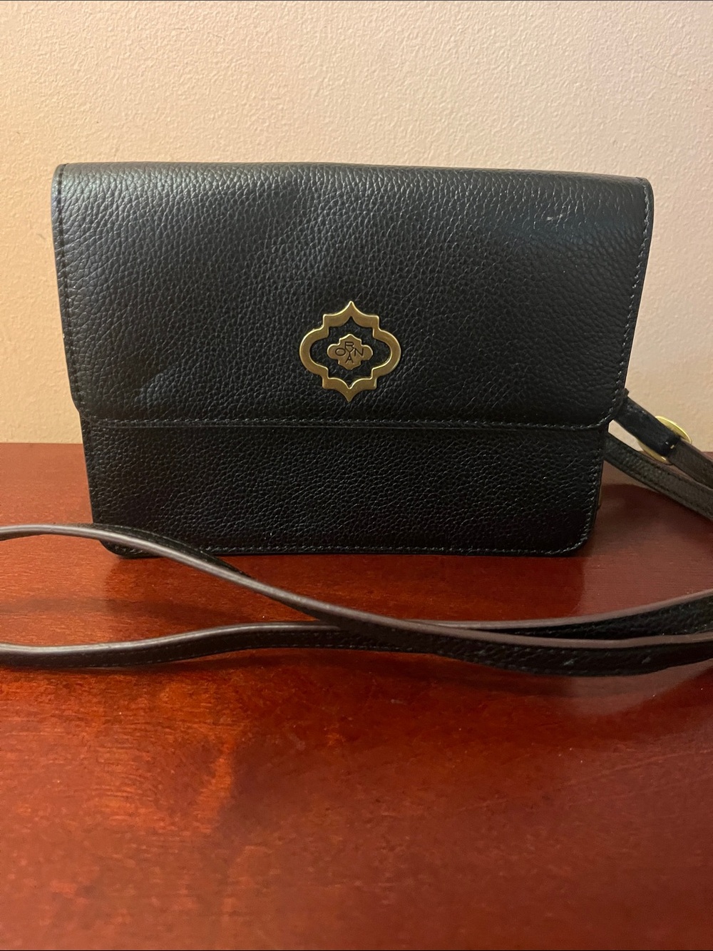 orYANY Black Pebbled Leather Crossbody with Gold Emblem